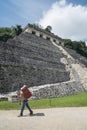 Local villager carries heavy load Palenque, Mexico